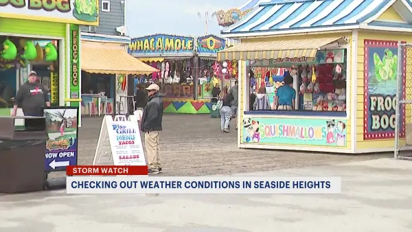 Last-minute beachgoers in Seaside Heights brave the rainy, gloomy weather