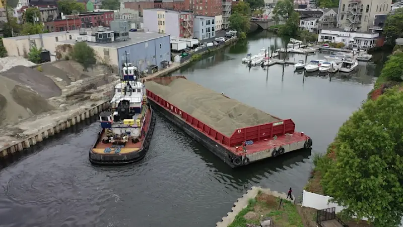Story image: ‘Teamwork.’ Barge freed after days stuck across Norwalk River; waterway reopens