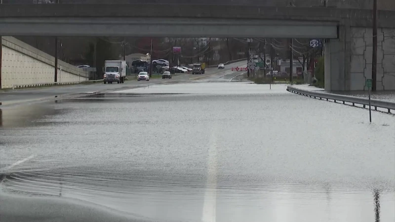 Story image: Route 59 floods again, creating massive delays as drivers diverted through parking lot