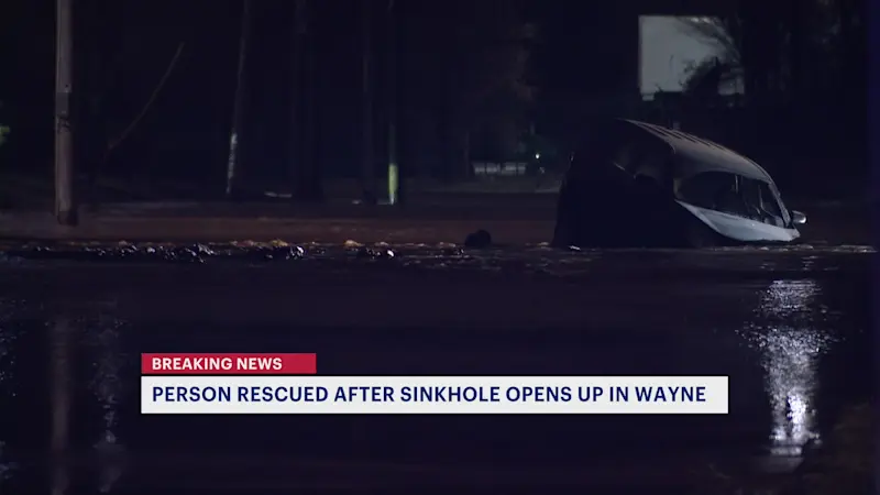 Story image: Crews rescue driver from sinkhole following water main break in Wayne