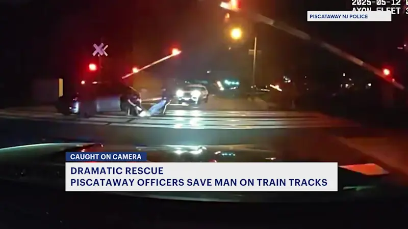 Story image: Caught on Camera: Heroic officers save man moments before train hits car in Piscataway
